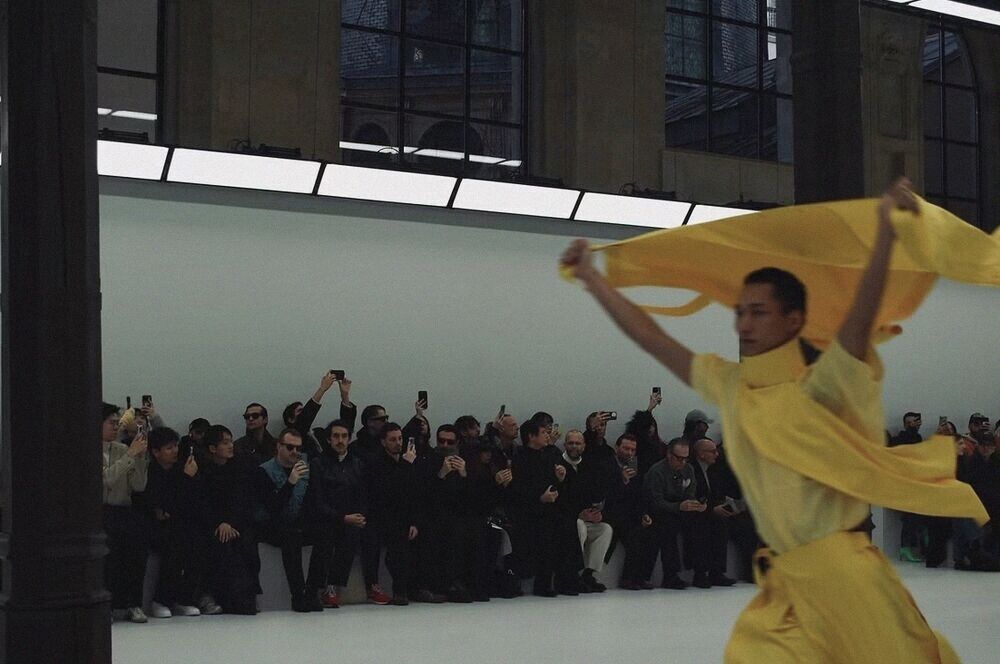 Dancer in yellow on a white runway