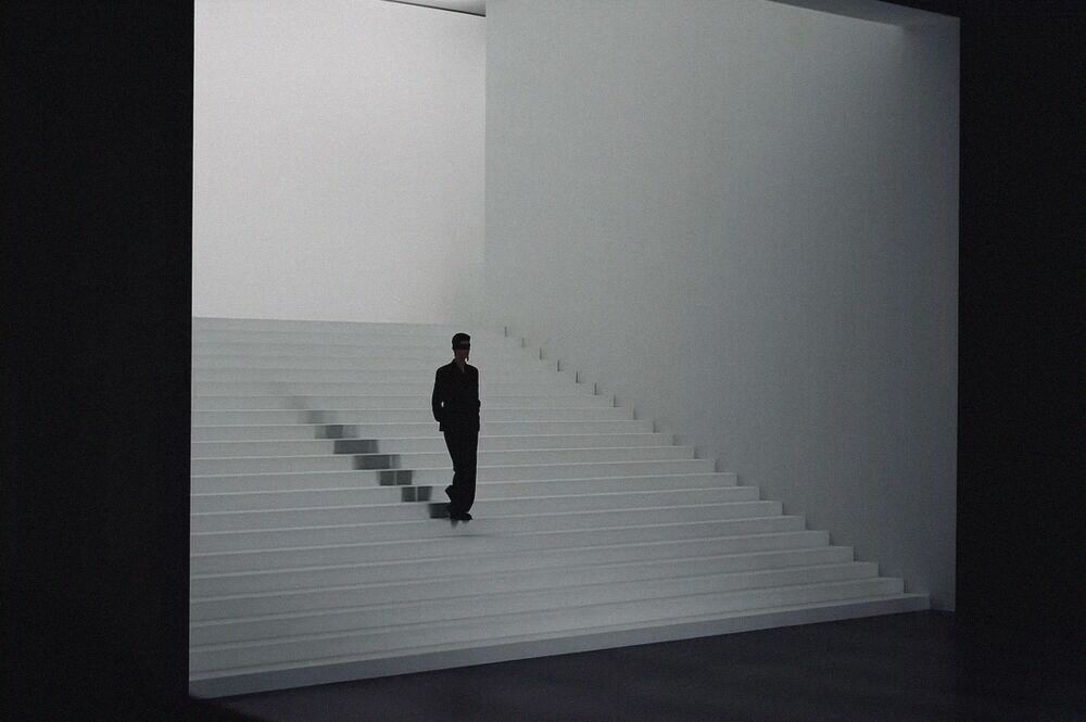 A lone figure on a wide white staircase