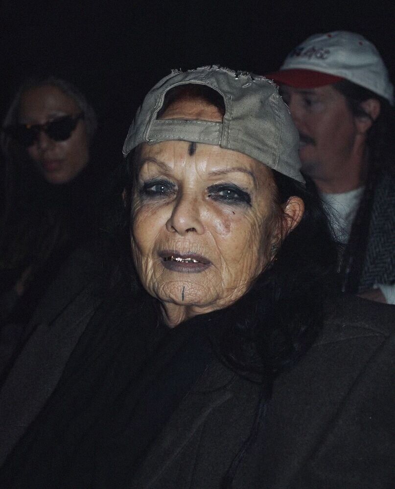 Close portrait of an older woman with face jewels