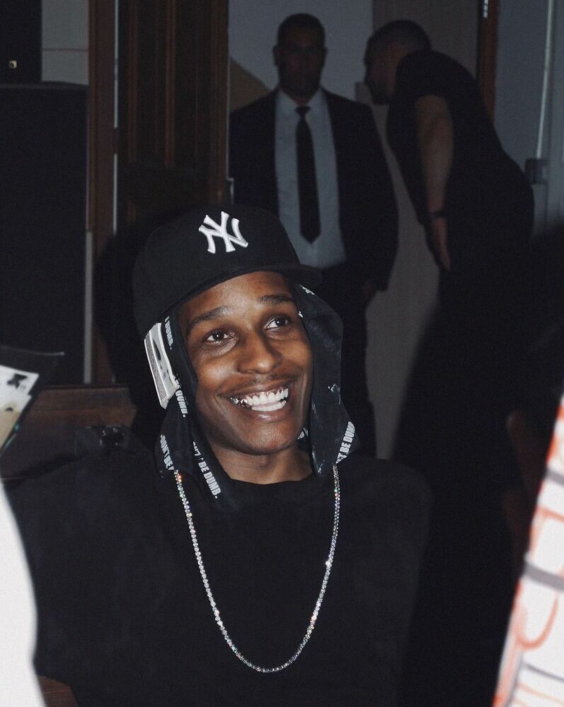 Smiling man in a New York cap