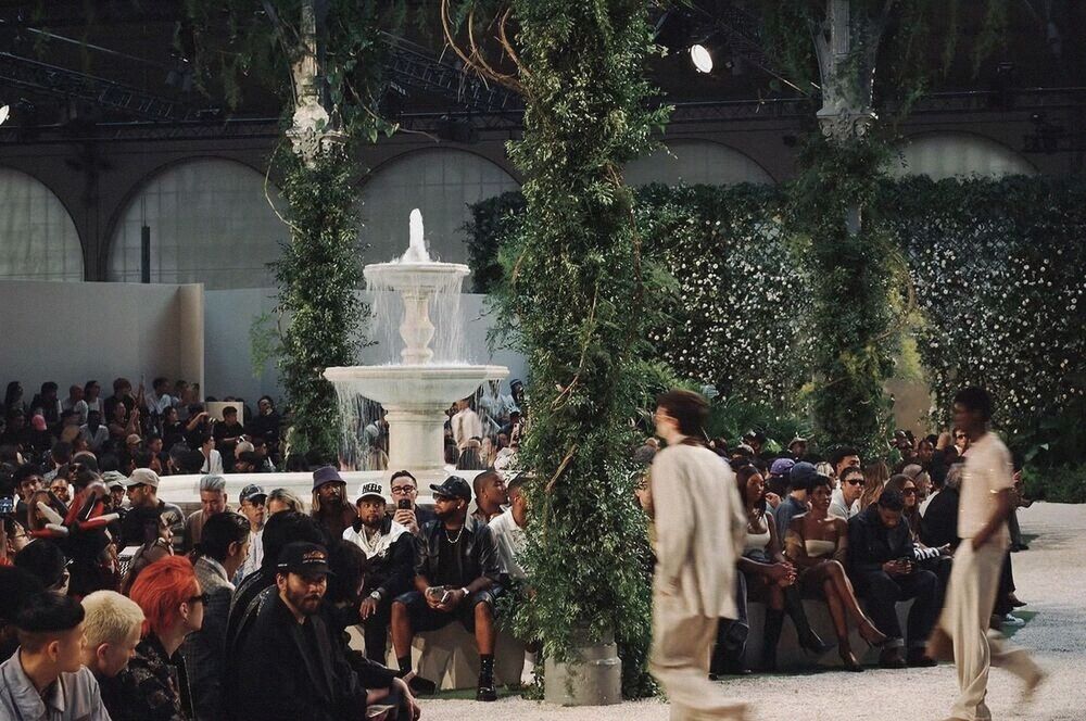 Runway set in a garden courtyard with a fountain