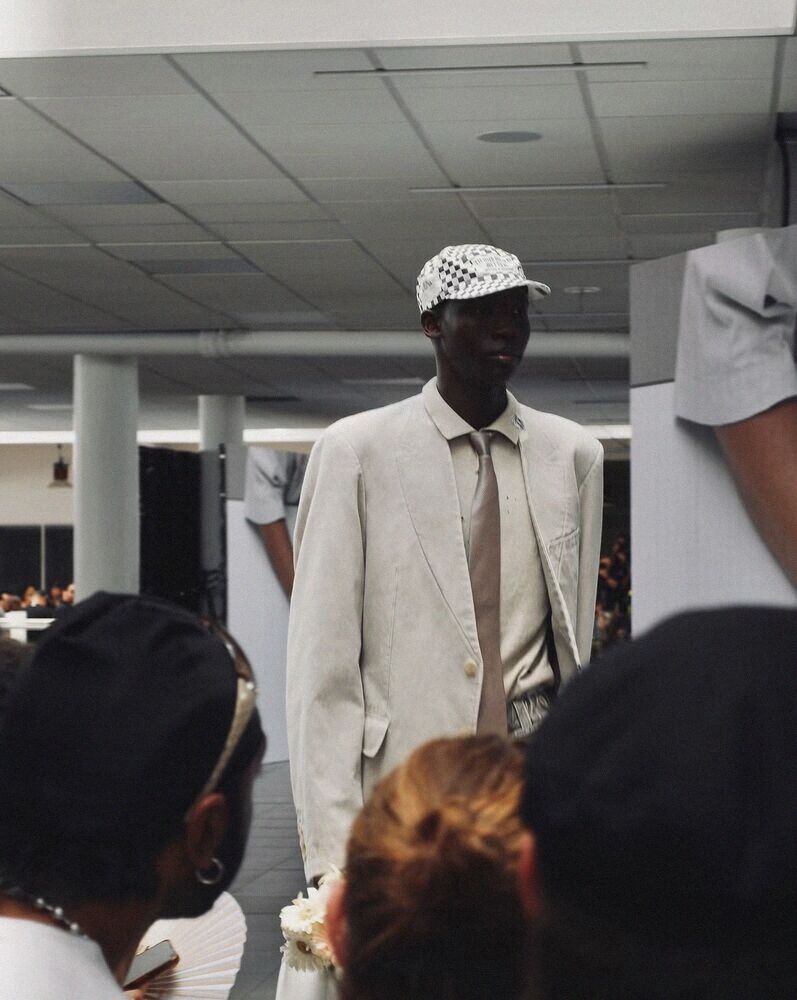 Model in a pale suit among the crowd