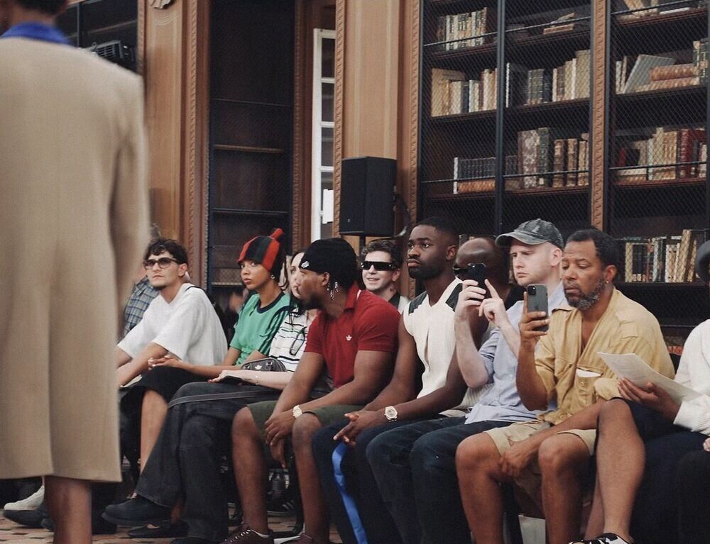 Front row guests in a wood-panelled library