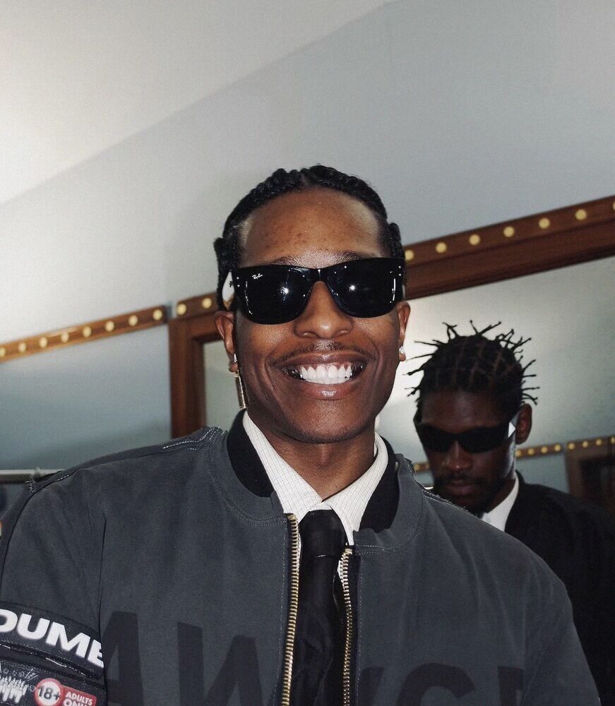 Man in sunglasses smiling in a theatre