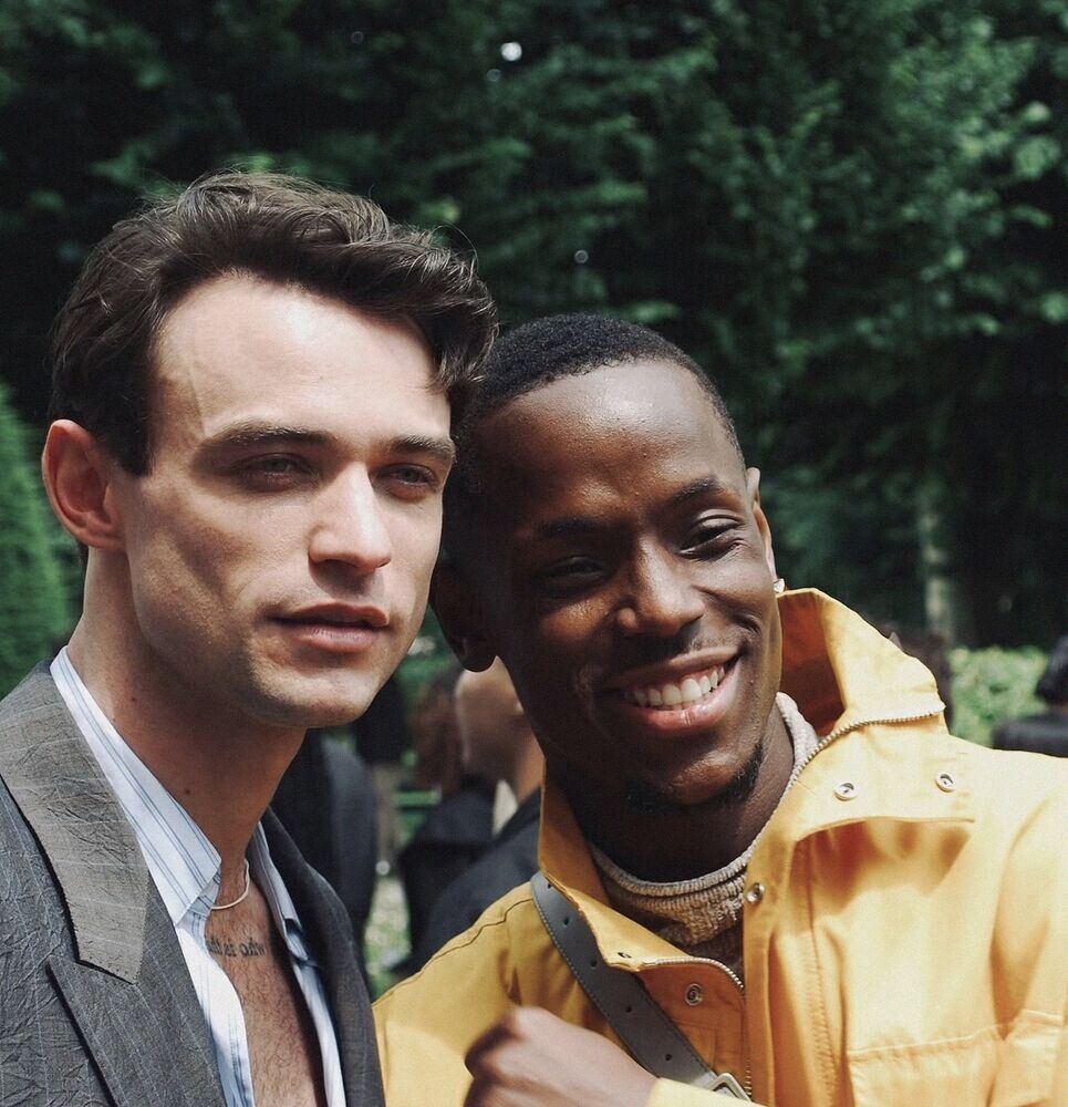 Two men grinning close to the camera